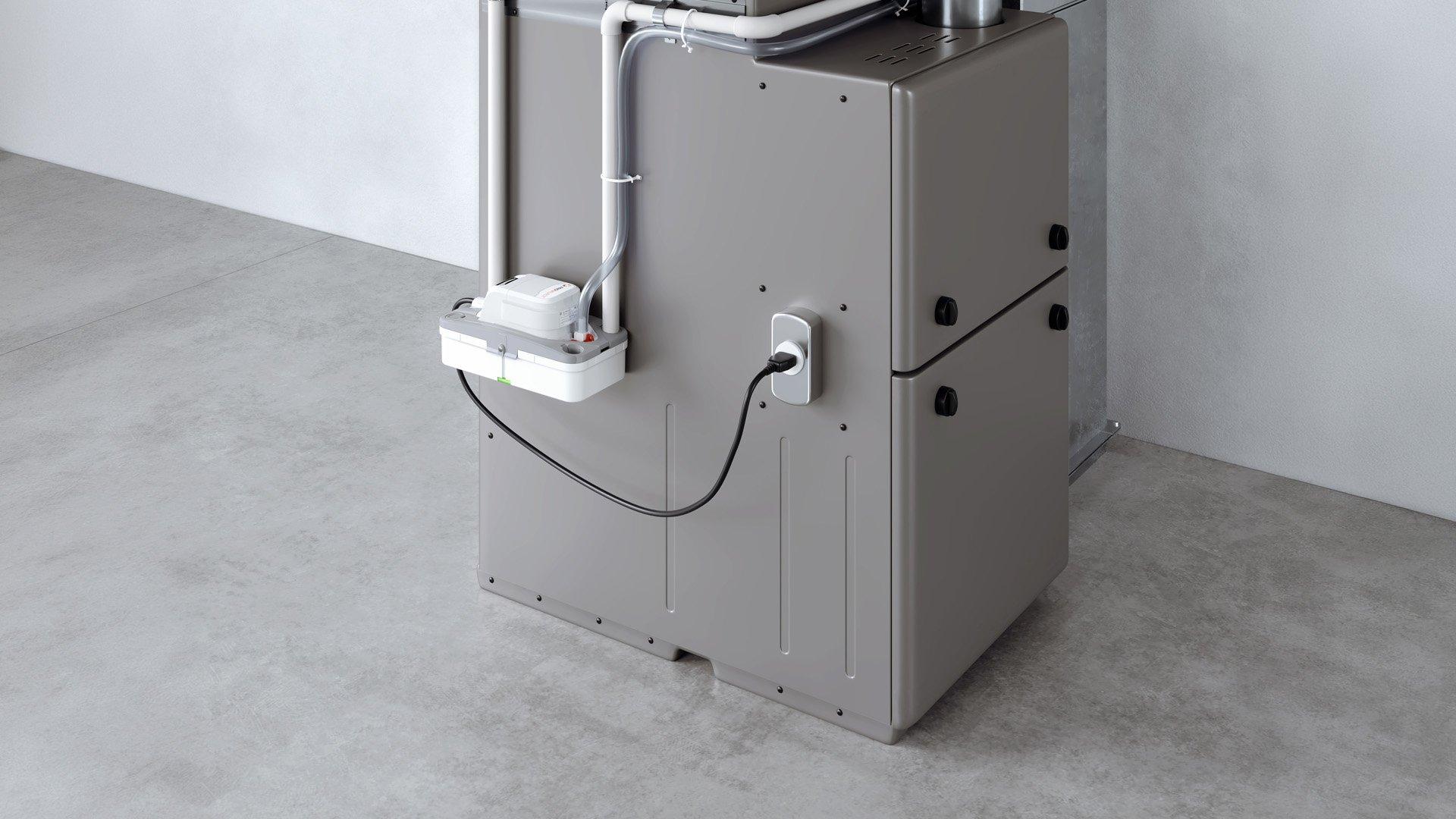 Condensate pump plugged into HVAC unit inside of residential building. 